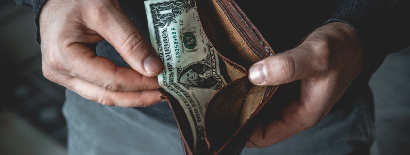 An Empty wallet in the hands of a young man