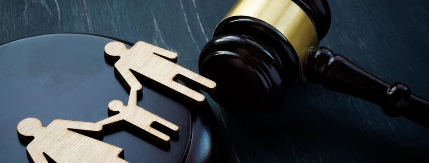 Family figures and court hammer. Family law and adoption concept.