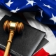 Gavel on wooden table with USA flag