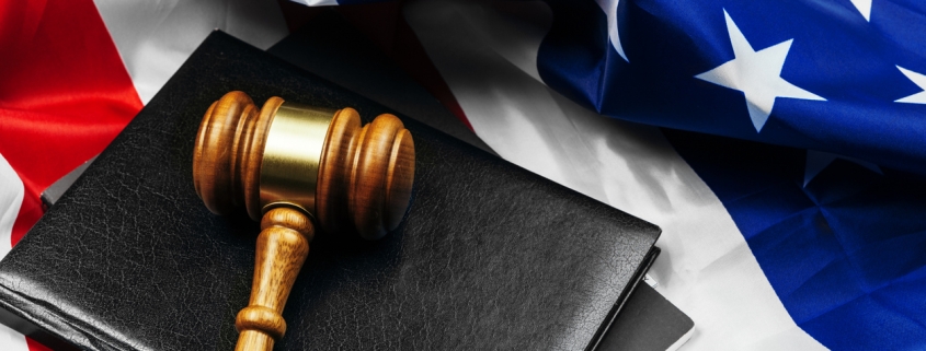 Gavel on wooden table with USA flag