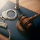 Handcuffs and wooden gavel. Crime, legal and violence concept.