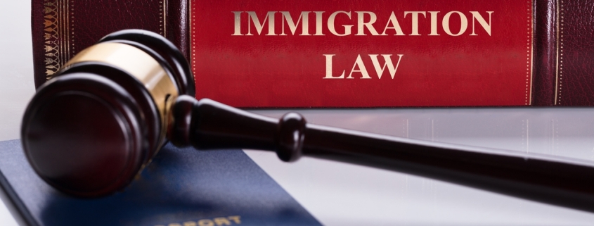 Close-up Of Gavel And Passport In Front Of Law Book